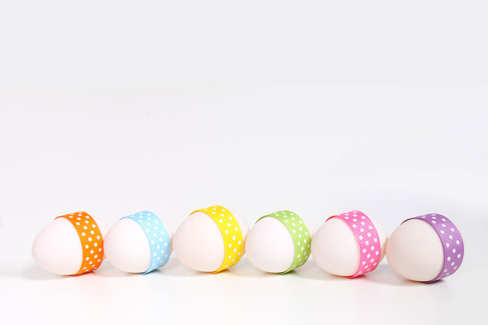10556 a line of easter eggs with ribbons isolated on a white background pv